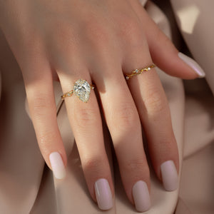 The Halo Twig Set With A 4 Carat Pear Moissanite
